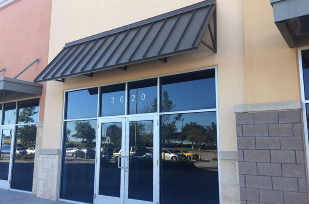 Standing-seam metal awning over glass storefront doors