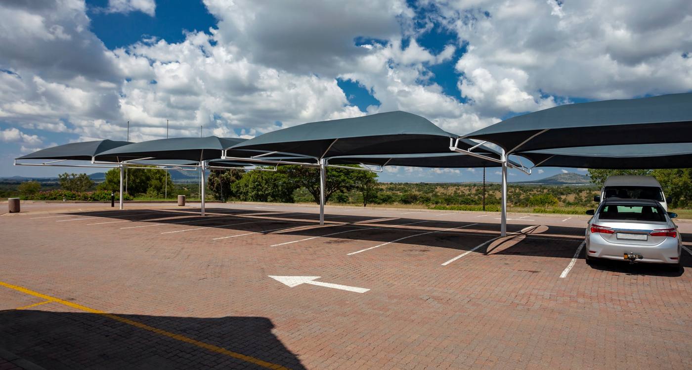 Fabric shade structures on steel posts over a parking area